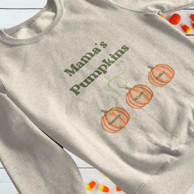 Beige crewneck custom Mama’s Pumpkins sweatshirt with green lettering and three named pumpkin designs