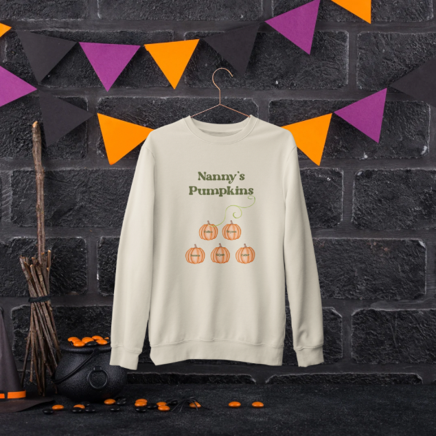 Cream crewneck sweatshirt with Nanny's Pumpkins print and five pumpkins in Halloween setting custom Mama’s Pumpkins sweatshirt