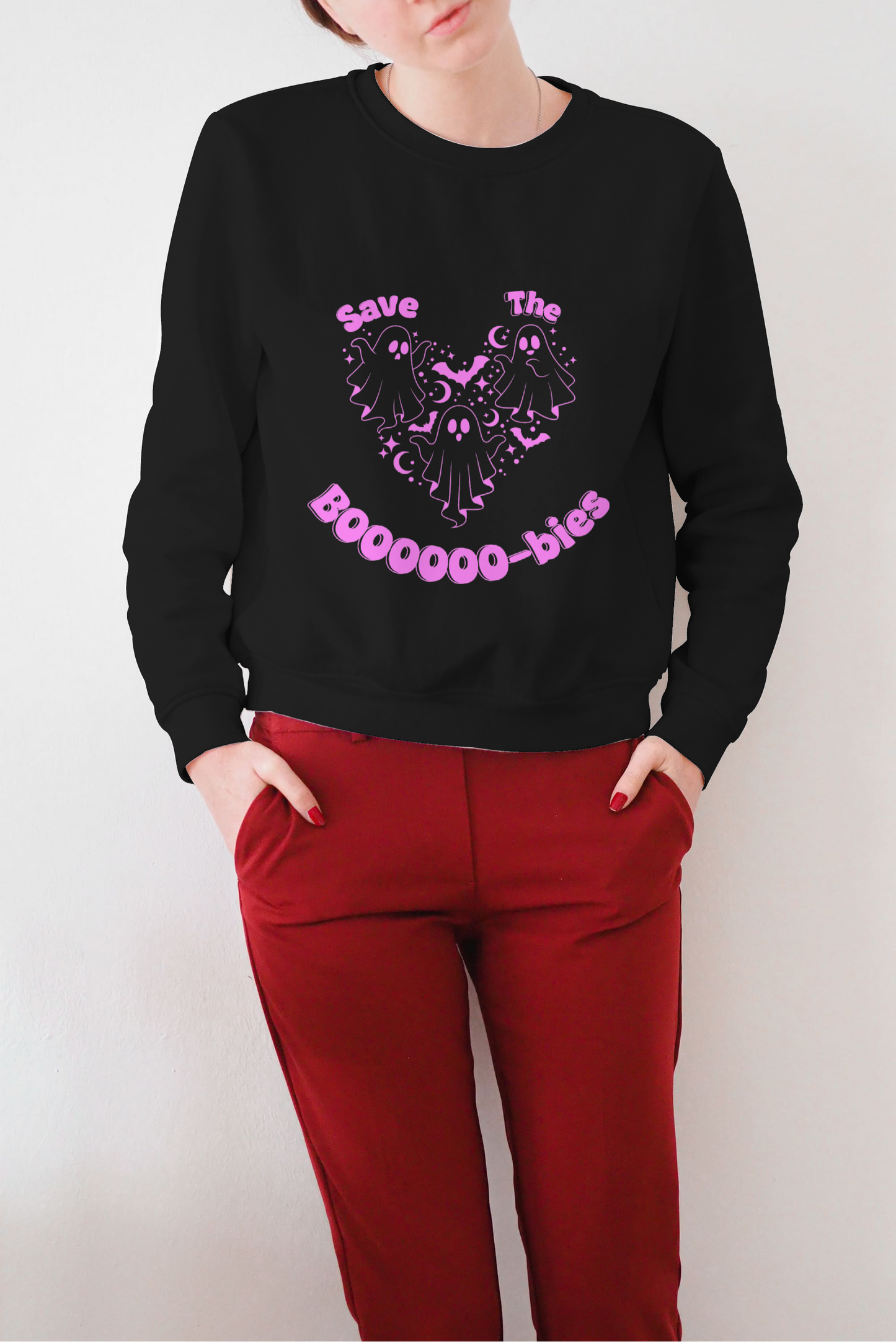 Model wearing Save the Boobies sweatshirt black crewneck with pink ghost heart graphic and red pants