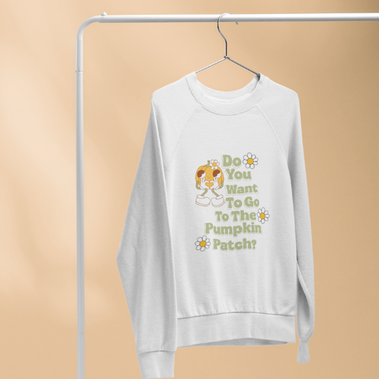 White crewneck sweatshirt on hanger showing retro girl graphic daisies and green text Do You Want To Go To The Pumpkin Patch sweatshirt