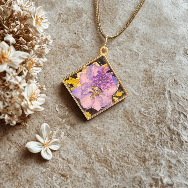 Gold square double-sided resin pendant with purple pressed flower and gold flakes on a chain