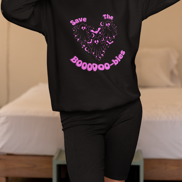 Model wearing black Save the Boobies sweatshirt featuring pink ghost heart graphic for breast cancer awareness